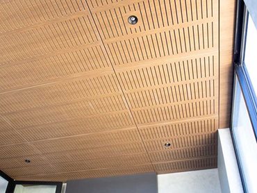 Key-Nirvana Classic Walnut acoustic ceiling tiles were chosen for their noise reduction capabilities as well as the all-natural finish